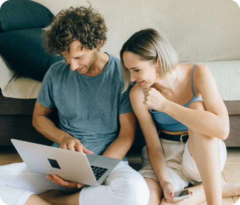Couple reviewing a rental report together on a laptop
